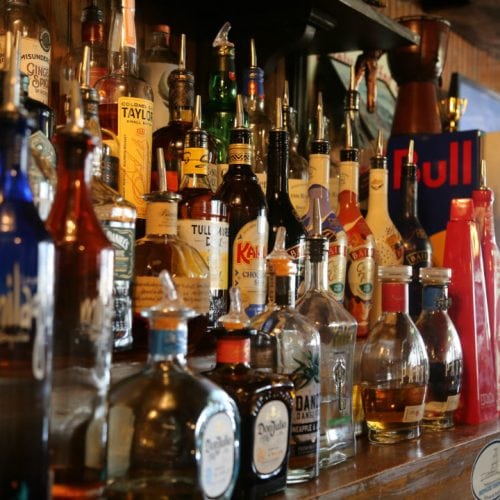 Bar shelf filled with liquor bottles